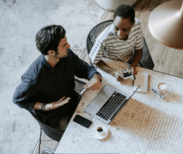 two-people-working-at-a-desk